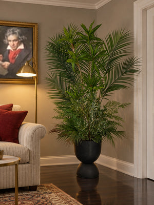 Plante artificielle Panoramique Végétal de 170 cm installée dans un coin de salon chic et chaleureux avec tableau et éclairage d'ambiance